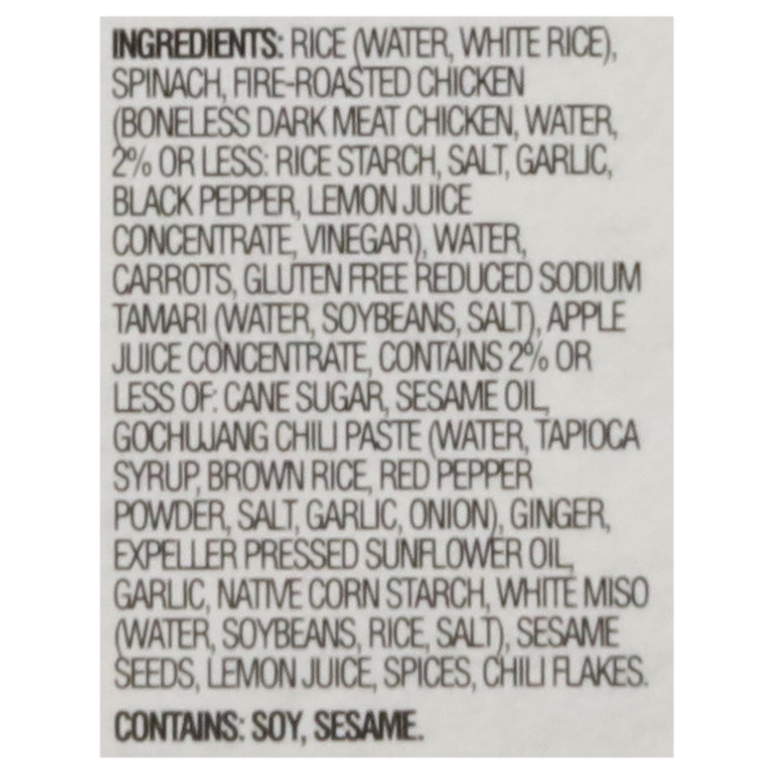 Ingredients list for Saffron Road Korean-Style Fire-Roasted Chicken. Main ingredients include rice, fire-roasted chicken, spinach, carrots, tamari, and gochujang chili paste. Contains soy and sesame.